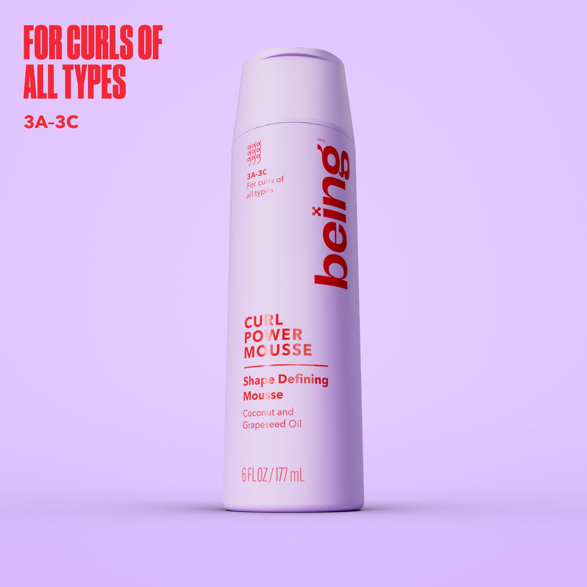 BEING INC close-up label highlighting coconut and grapeseed oil benefits for curls
