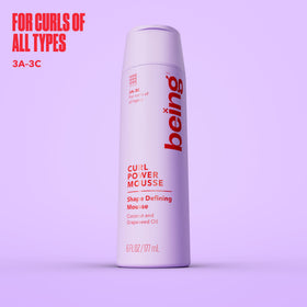 BEING INC close-up label highlighting coconut and grapeseed oil benefits for curls