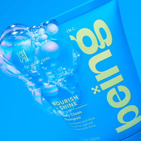 BEING INC creamy conditioner being applied to hair, showing detangling action