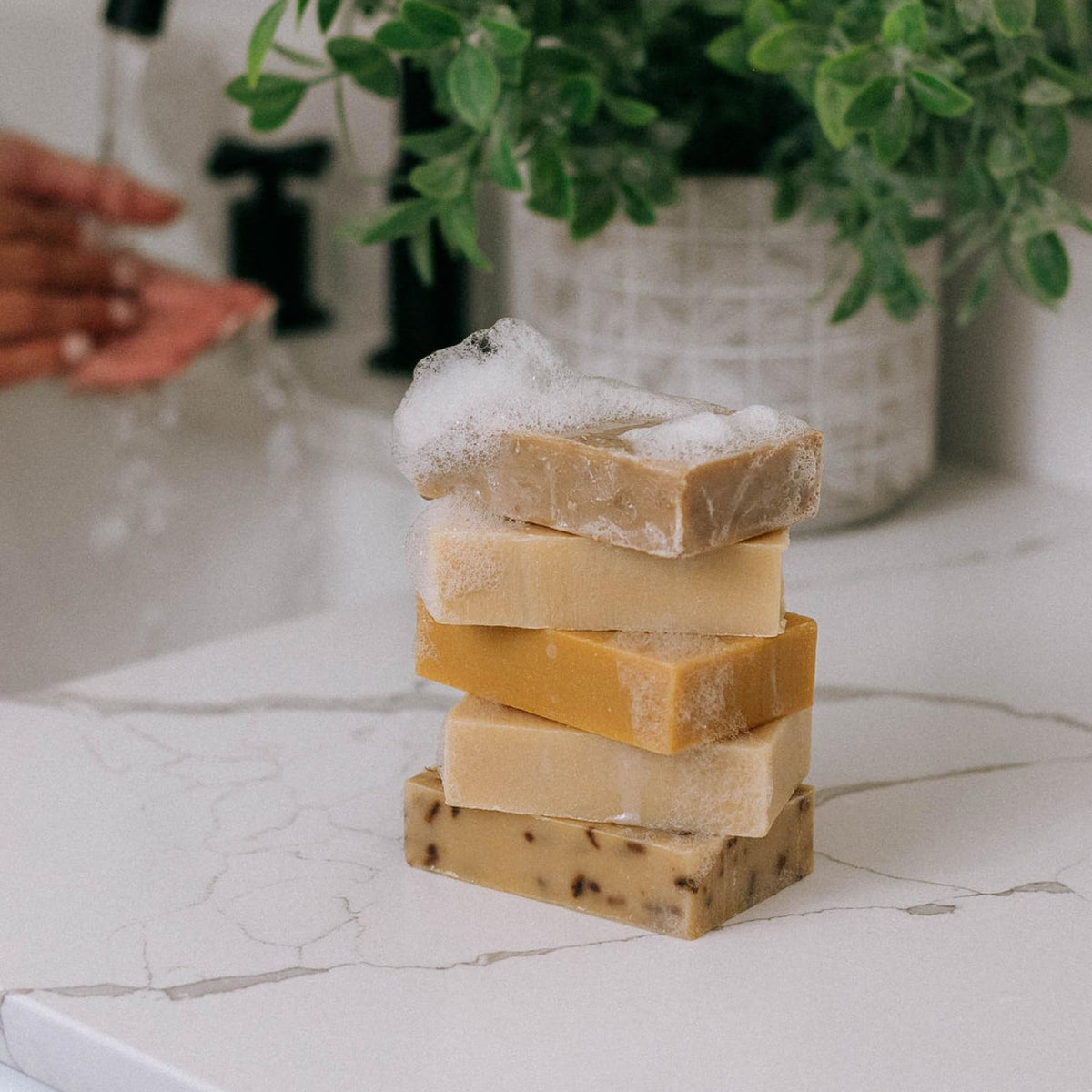 Flatlay of Bend Soap Company ingredients highlighting goat milk and oils for nourishing formula