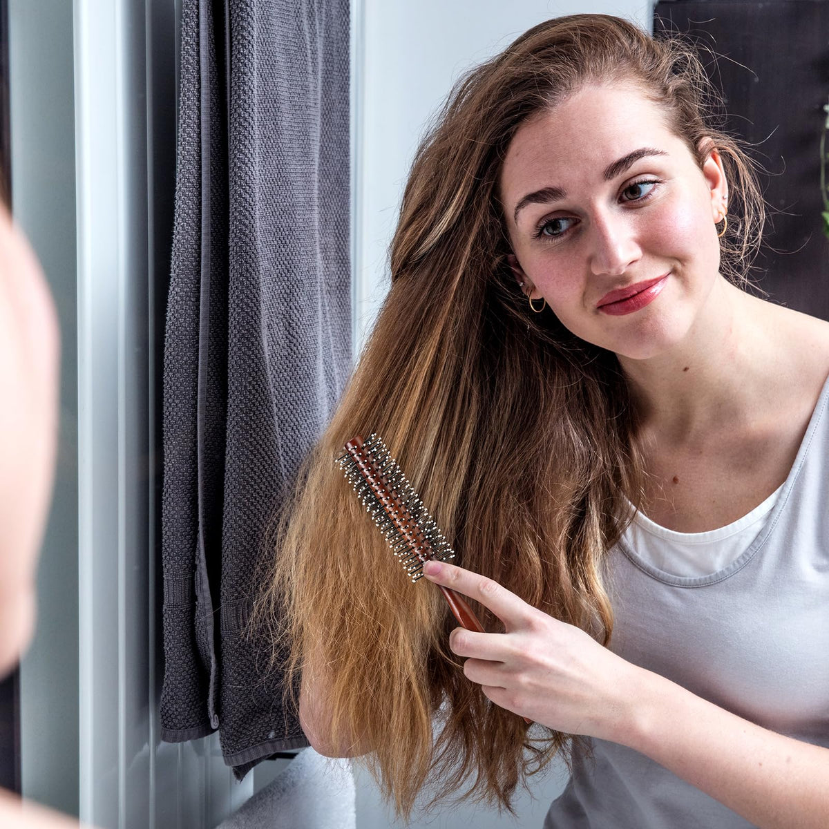 BESTOOL brush held in hand to show compact scale and travel-friendly size benefit