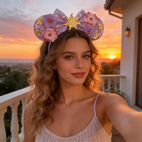 bianbaistar close detail of sequin bow with golden sun charm, highlights decorative focal point