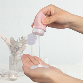 BienBion wide-mouth bottle being refilled with shampoo for easy pouring