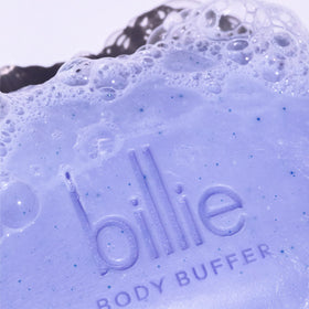 Billie body buffer held in hand to show compact curved size and ergonomic fit