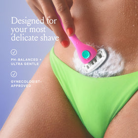 Billie beside razor and towel showing shave-ready pairing for reduced irritation