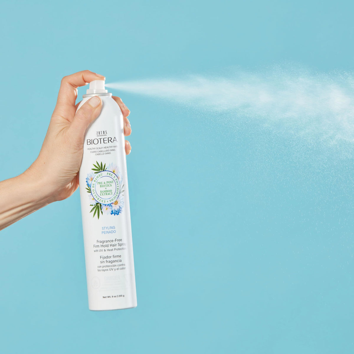 Close-up mist of Biotera hairspray highlighting fine texture and residue-free finish