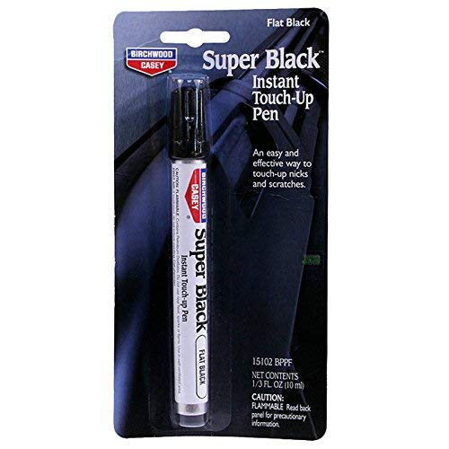 Birchwood Casey pen beside coin showing compact size and portability