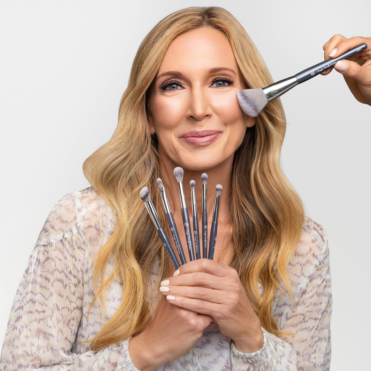 BK BEAUTY brush angled on cheek demonstrating placement and lifted cheekbone benefit