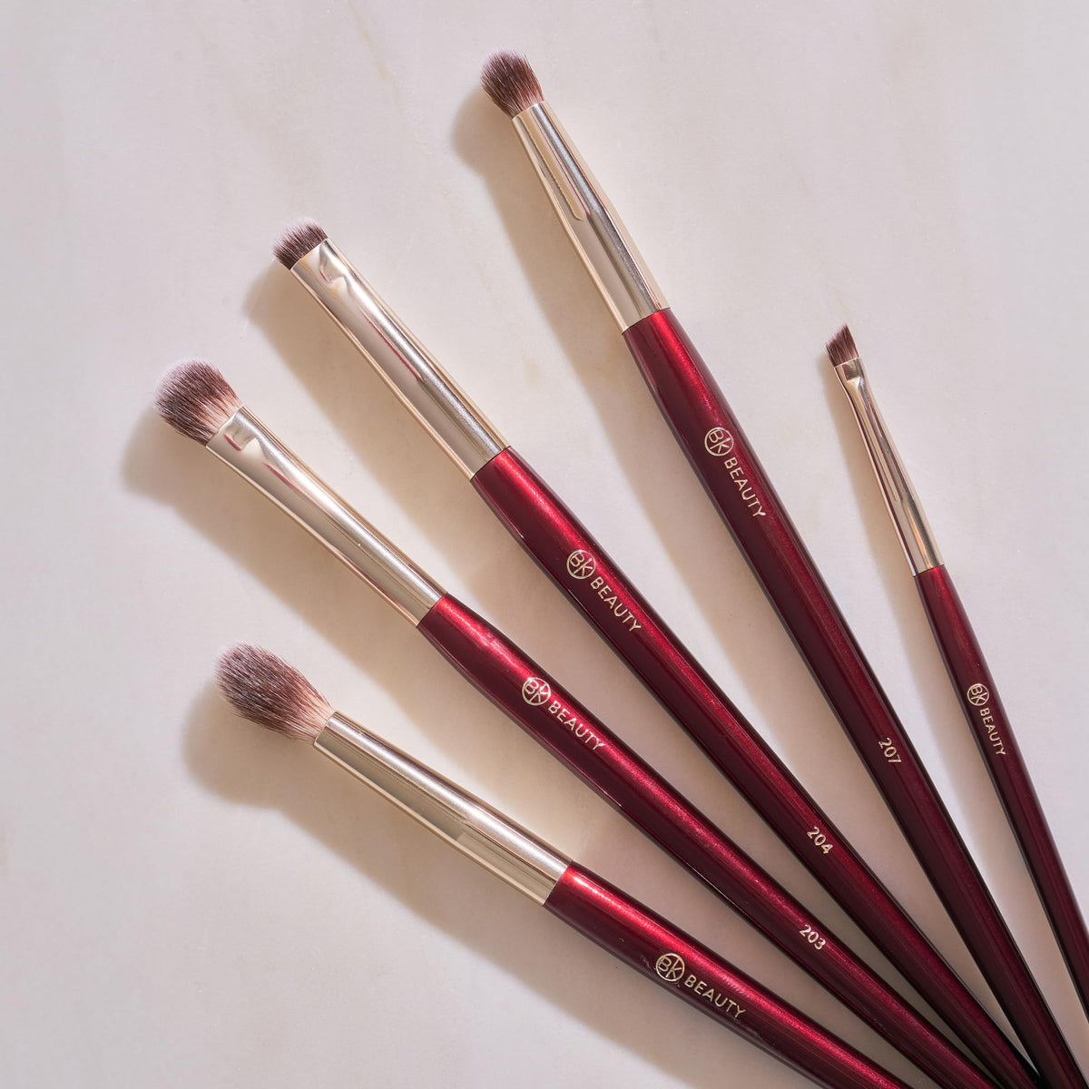 BK BEAUTY brushes next to ruler and pouch showing compact travel-ready size