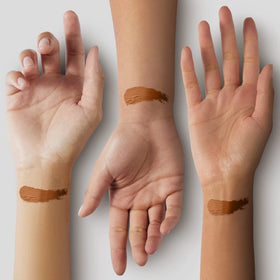 Black Radiance stick held in hand showing scale and travel-friendly benefit