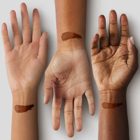 Black Radiance foundation stick being applied to cheek for targeted coverage and contouring