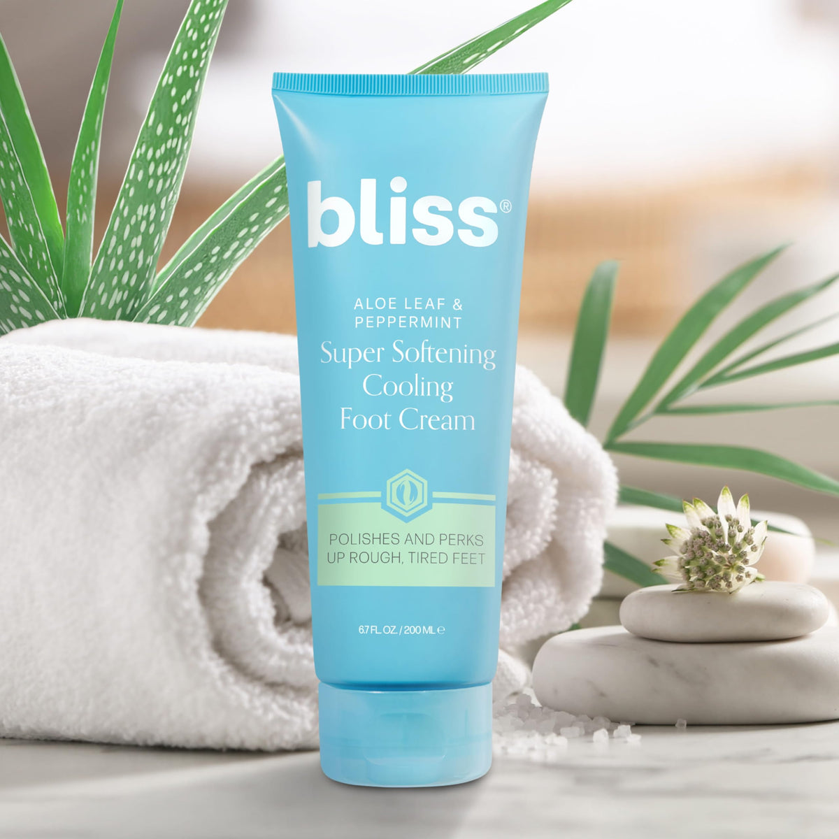 Bliss 4.0 fl oz tube next to a coin for scale showing portable at-home foot treatment