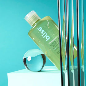 Bliss beside ruler showing 10 fl oz size and travel-friendly volume benefit