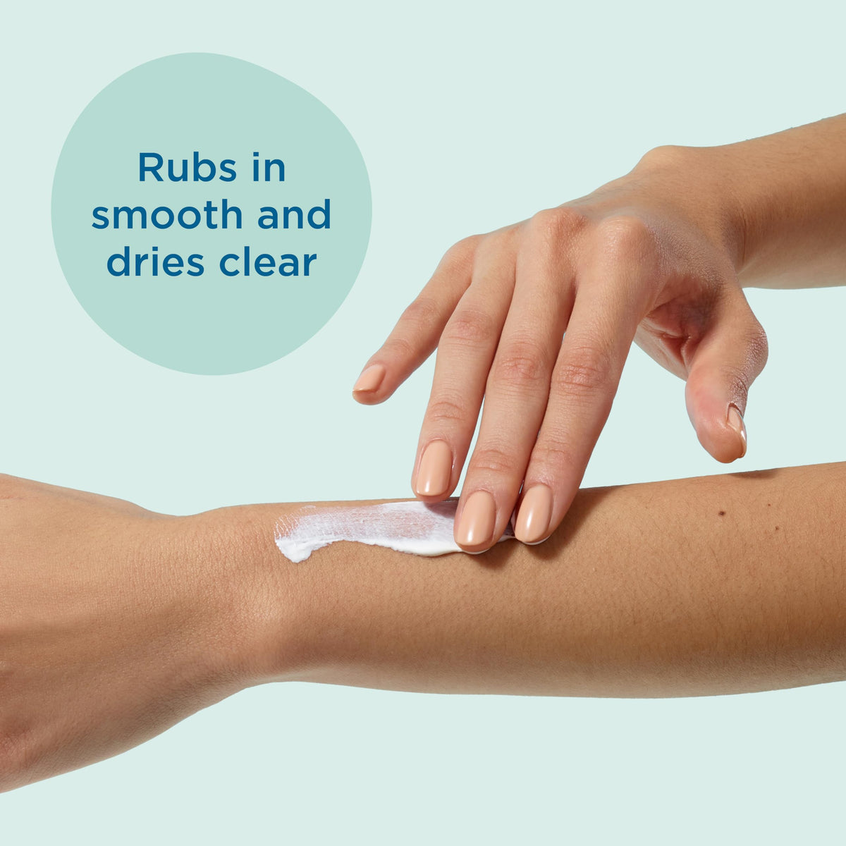 Applying Blue Lizard sunscreen to forearm showing even coverage and protection