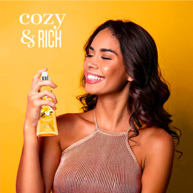 Body Fantasies bottle in a hand showing size and travel-friendly convenience