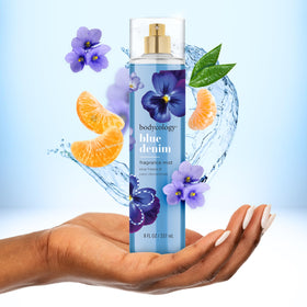 Bodycology Blue Denim bottle held in hand to show actual 8 fl oz size and travel readiness