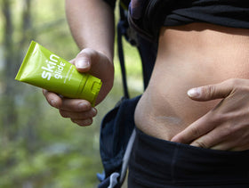 Runner applying BodyGlide before a run, reduces chafing and stays dry