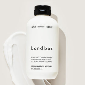 Bondbar conditioner being applied to wet hair demonstrating detangling benefit