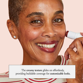 BOOM! by Cindy Joseph stick next to a hand showing compact size and on-the-go convenience