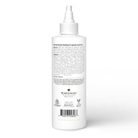 Bounce Curl shampoo on bathroom shelf in lifestyle setting for routine appeal