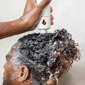 Bounce Curl next to ruler showing 8 oz scale for travel-friendly convenience