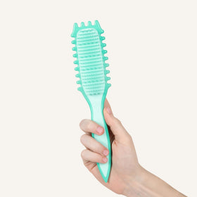 Bounce Curl brush being used on wet hair showing gentle detangling and reduced breakage