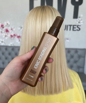 Brazilian Blowout bottle beside a brush to show 3.4 fl oz scale and travel-friendly convenience