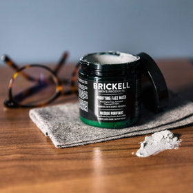 Brickell jar held in hand to show size and travel-friendly convenience
