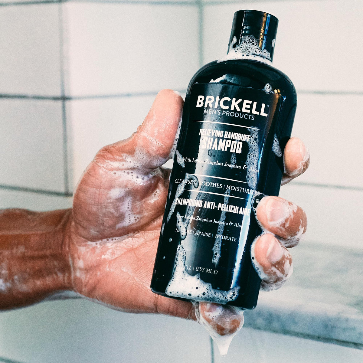 Brickell conditioner cream poured showing rich texture that hydrates and soothes scalp