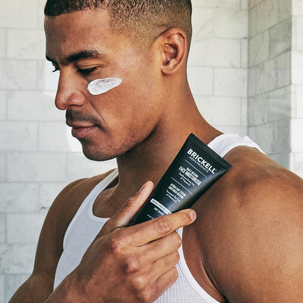 Brickell Men's Products being applied to male face demonstrating non-greasy protection benefit