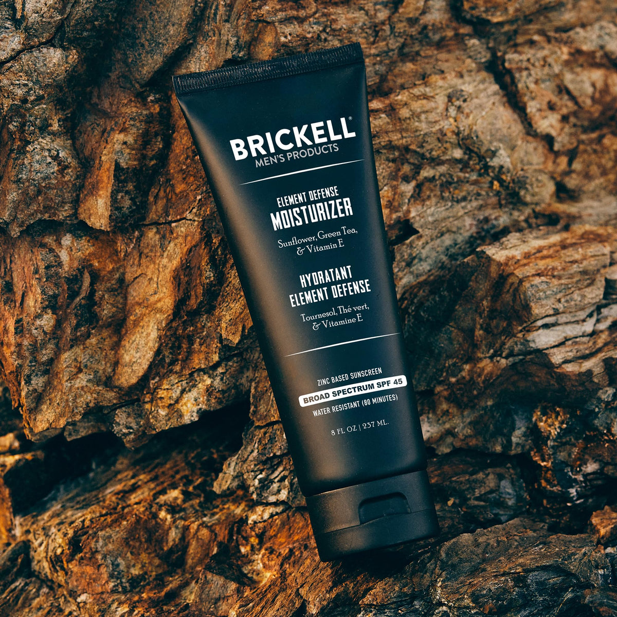 Brickell Men’s applying moisturizer to face showing smooth, non-greasy finish benefit