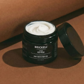 Brickell Men's 2 oz jar held in hand to show scale benefit: travel-friendly size