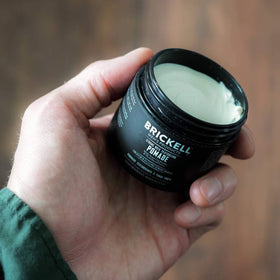 Brickell Men’s Products jar in a travel toiletry bag showing portability and convenience