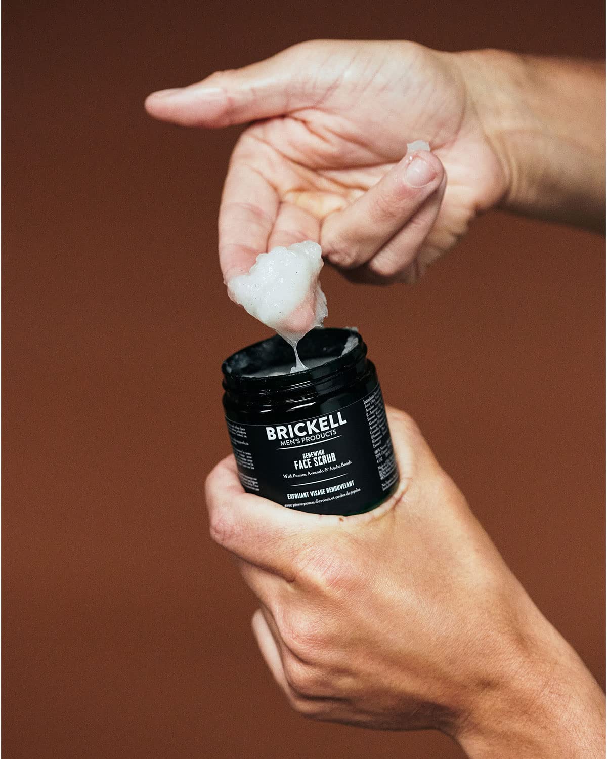 Brickell 2 ounce tube in hand emphasizing travel-friendly grooming convenience
