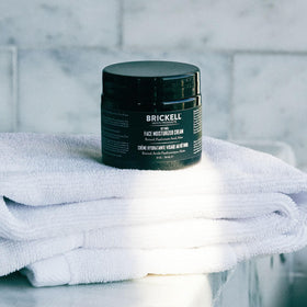 Brickell Men's Products staged in bathroom nighttime routine setting for grooming benefit
