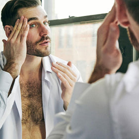 Brickell Men's Products applied to jawline by man demonstrating easy layering and smooth finish
