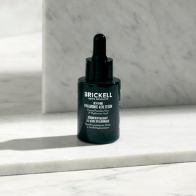 Brickell Men's Products clear gel drop on fingertip showing lightweight texture and quick absorption