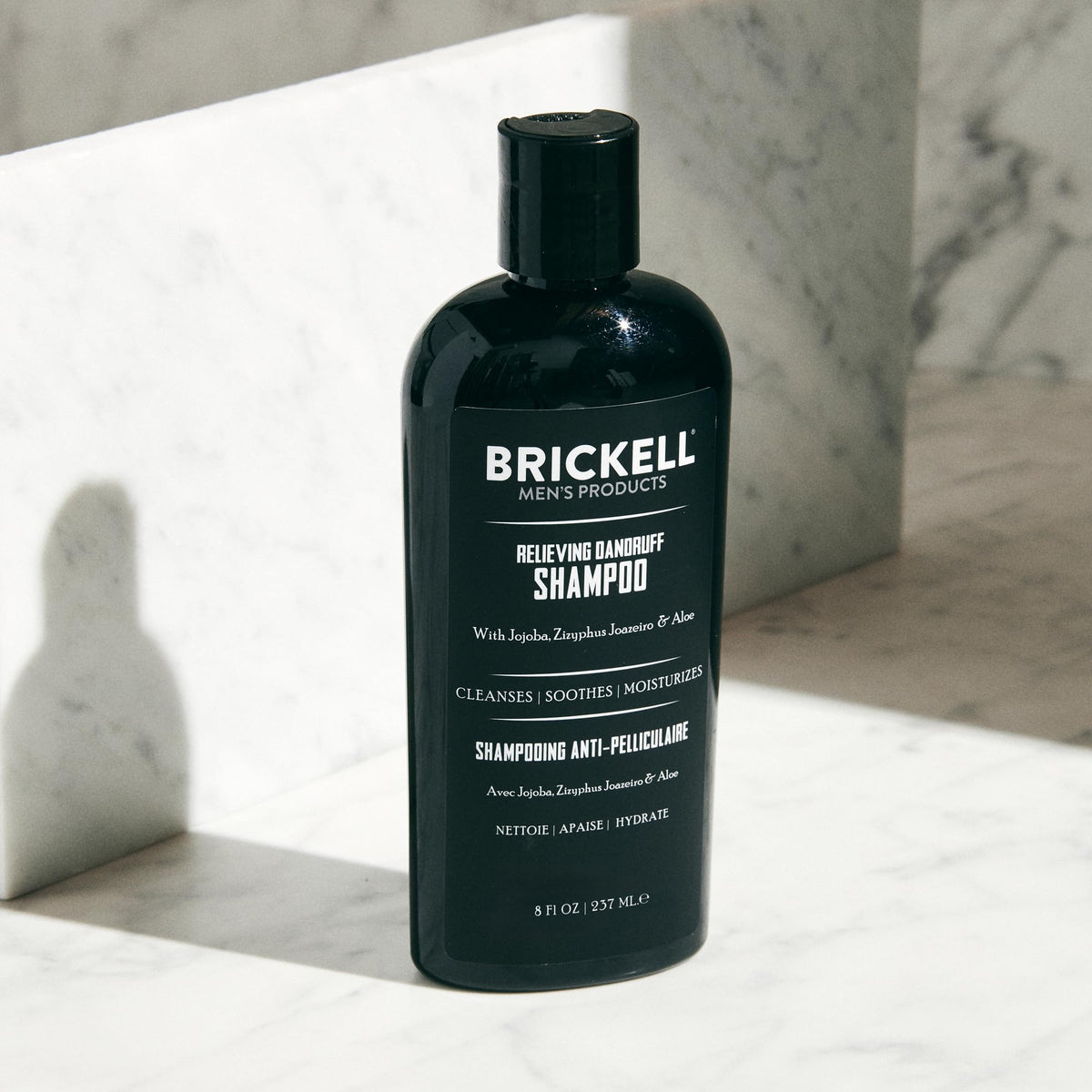 Brickell shampoo in hand during use showing soothing scalp relief