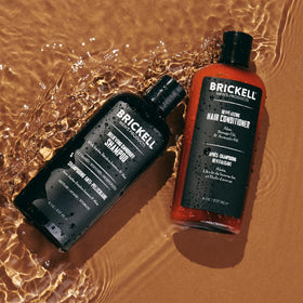 Brickell bottles in hand to show size and travel-friendly scale for daily routine