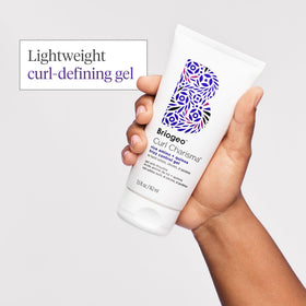 Briogeo application on damp curly hair demonstrating even distribution