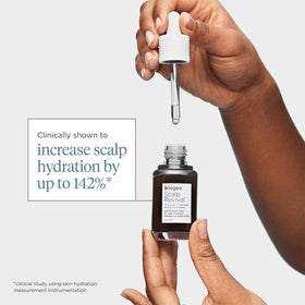 Briogeo applying serum to scalp showing targeted treatment for flakes and itch