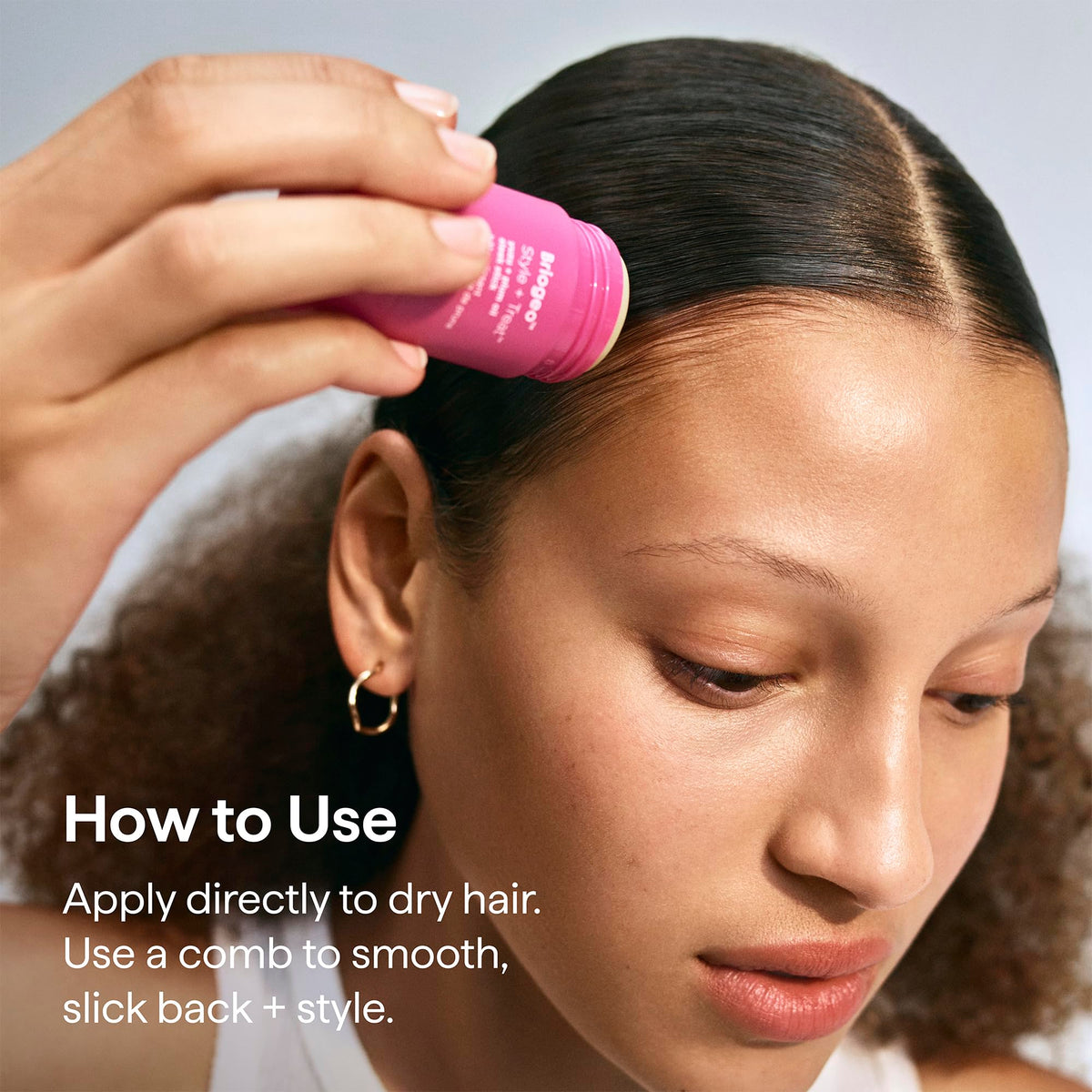 Briogeo sleek stick placed on a makeup bag for on-the-go touch-ups