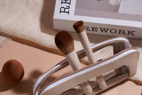 BS-MALL size comparison in hand to show compact brushes and travel-ready scale