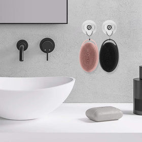 Bsofing scrubber hung by handle next to hand for scale, compact and easy storage