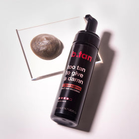 B.TAN bottle next to ruler showing 6.7 fl oz scale and portability