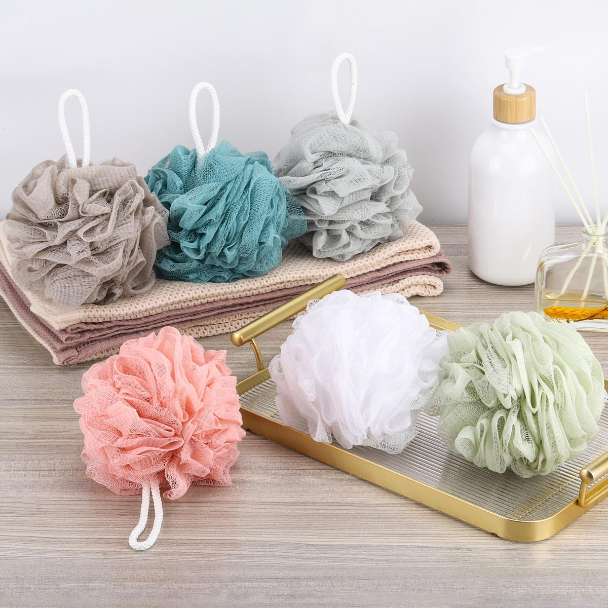 BTYMS pouf hung by loop on a shower rail to air dry and reduce odor