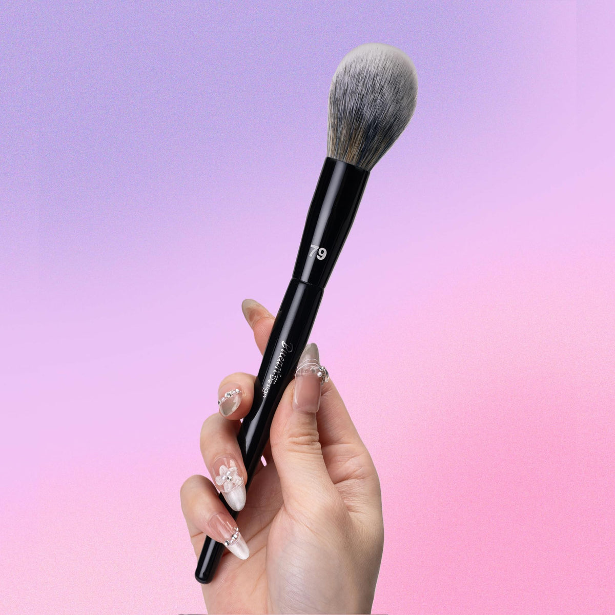 Bueart Design brush in use applying under-eye powder for smooth, precise finish