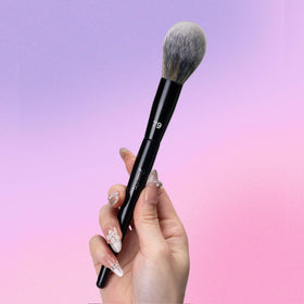 Bueart Design brush in use applying under-eye powder for smooth, precise finish