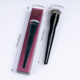 Bueart Design brush next to hand showing size and portability for travel-ready use