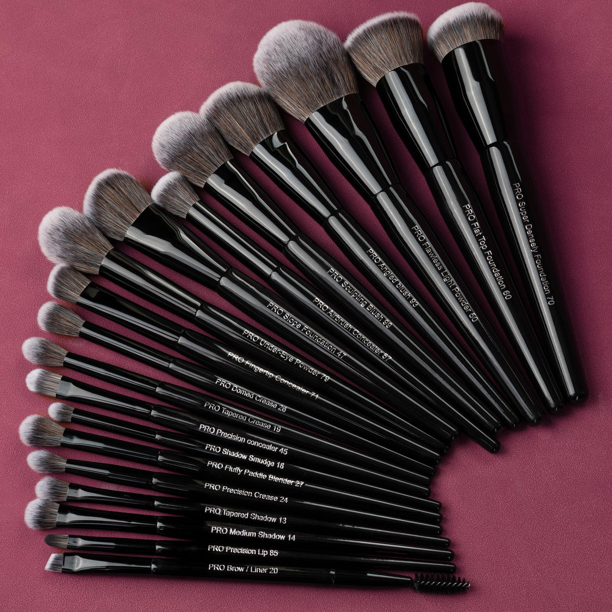 Bueart Design brushes held in hand showing scale and practical size for travel